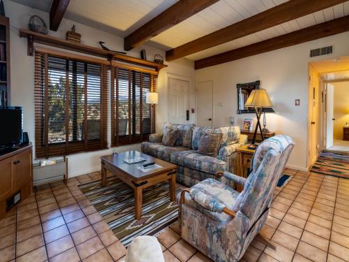 a living room with couches and a table and a tv at Artist Road #31 in Santa Fe