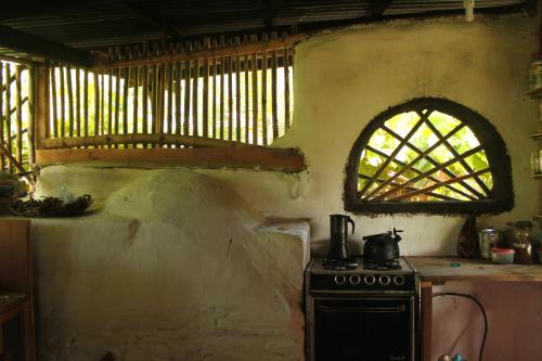 a kitchen with an old stove and a window at Finca La Magia in Ometepe