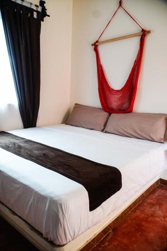 a bedroom with a bed with a red net on it at C 33 Hospedaje Valladolid in Valladolid