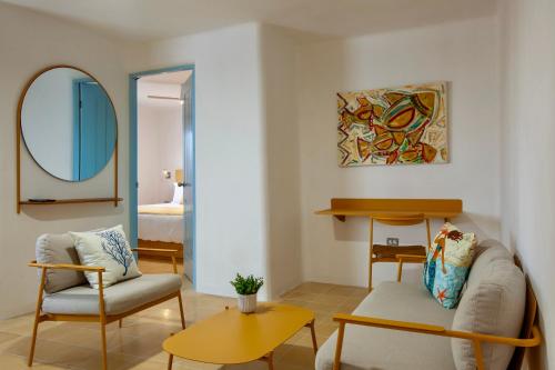 a living room with a couch and a mirror at Villa Esterito - La Paz Baja California Sur in La Paz