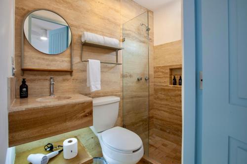 a bathroom with a toilet and a sink and a mirror at Villa Esterito - La Paz Baja California Sur in La Paz