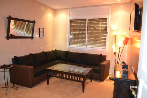 a living room with a couch and a coffee table at Europa mirlef t aventur Guest House in Mirleft