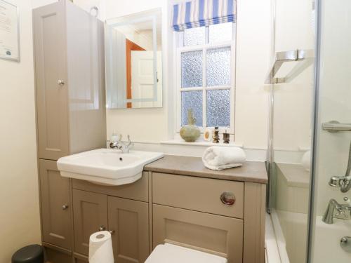 a bathroom with a sink and a toilet and a shower at 1 The Cross in Dunkeld