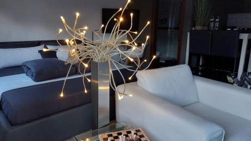 a living room with a couch and a table with lights at K82 BNB & Hotel in Kirchentellinsfurt