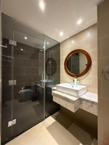 a bathroom with a sink and a glass shower at AHoa StarCity with Seaview in Nha Trang