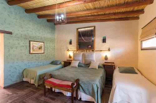 a bedroom with two beds in a room at La Posada del Rio in Tilcara