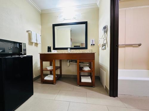 a bathroom with a sink and a mirror and a tub at The Hills Inn Eagle Rock - Near Old Town Pasadena in Los Angeles