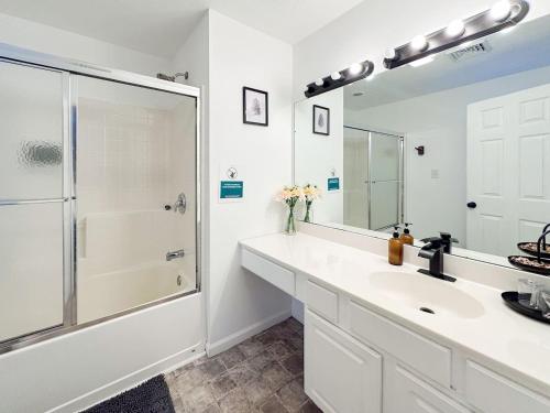 a white bathroom with a sink and a shower at HotTub|Sauna|Theater|BBQ|Firepit|Game|Pool in Long Pond