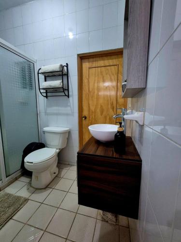 a bathroom with a toilet and a sink at Downtown Suite Wifi in Morelia
