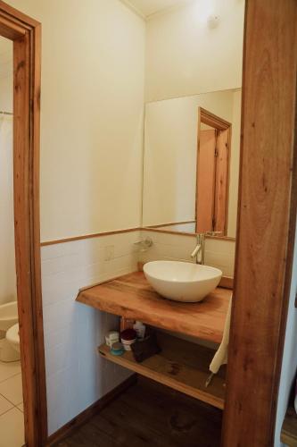 a bathroom with a sink and a mirror at Casa en Las Perdices, Carmelo in Carmelo