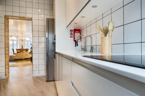 a kitchen with a counter and a refrigerator at Cidadela do Viriato Deluxe in Viseu