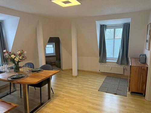 a living room with a table and a dining room at Apartment am Ostorfer See in Schwerin
