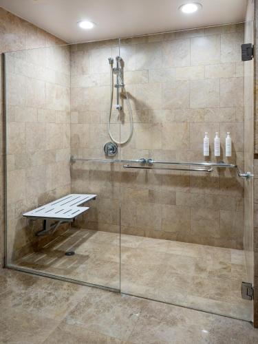 a bathroom with a shower with a glass door at Palm Beach Marriott Singer Island Beach Resort & Spa in Palm Beach Shores