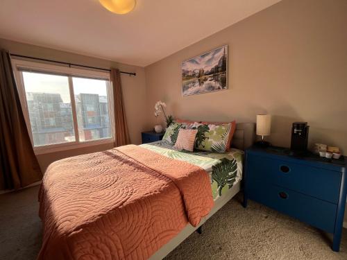 a bedroom with a bed and a window at Sunlit Haven in Calgary