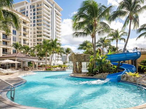a pool at a resort with a water slide at Palm Beach Marriott Singer Island Beach Resort & Spa in Palm Beach Shores