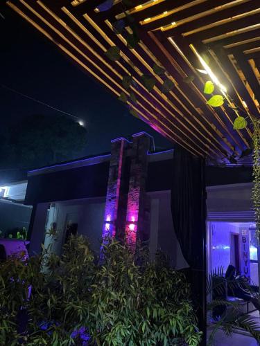 a building with purple lights on it at night at Binyuma Suites Motel in Kampala