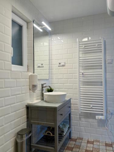 a bathroom with a sink and a mirror at Avar Inn in Tiszalök
