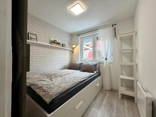 a bedroom with a bed against a brick wall at Avar Inn in Tiszalök