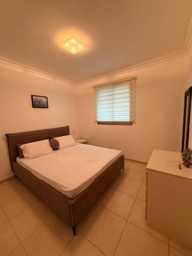 a bedroom with a bed and a window at נוף ראשון לים in Ashkelon