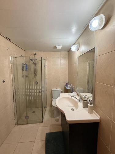 a bathroom with a shower and a sink and a toilet at נוף ראשון לים in Ashkelon