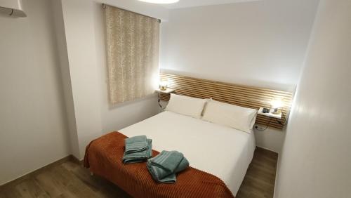 a bedroom with a bed with two towels on it at Los Naranjos de Marbella in Marbella