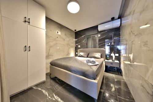 a bedroom with a bed and a sink in it at סוויטות חוף האהבה in Haifa