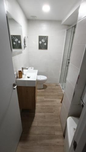 a white bathroom with a sink and a toilet at Los Naranjos de Marbella in Marbella