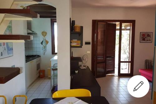 a kitchen with a table and a dining room at Villa Celeste in Torre delle Stelle