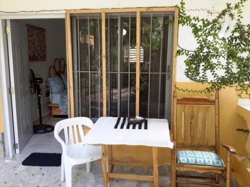 a table and chairs in front of a glass door at Villa Mar Sosua in Sosúa