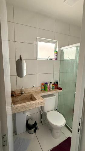 a bathroom with a toilet and a sink and a shower at Casa condominio Reserva do Delta 07 in Parnaíba