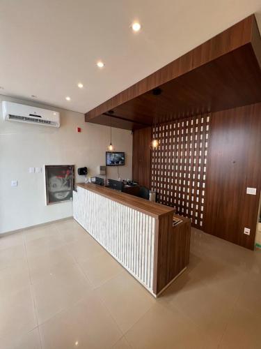 a lobby with a bar with a couch and a tv at HOTEL PLAZA PONTES e LACERDA in Pontes e Lacerda