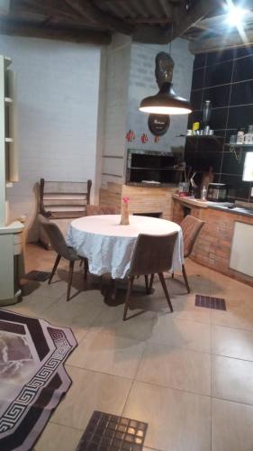 a kitchen with a table and chairs in a room at Chalé da Janete in Capão da Canoa