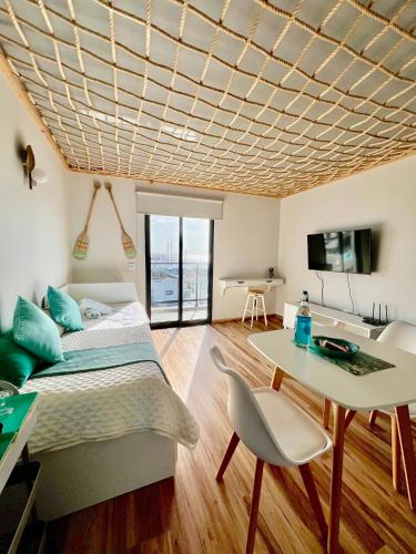 a living room with a bed and a table and a couch at Caniçal houses - Madeira in Caniçal