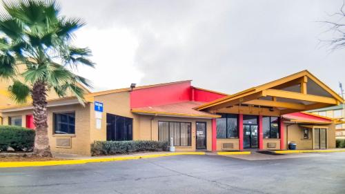 a building with a palm tree in front of it at Travelodge by Wyndham Houston Hobby Airport in Houston