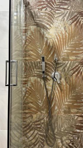a bathroom with a shower with a glass door at Lumèra Holiday Home in Pizzo