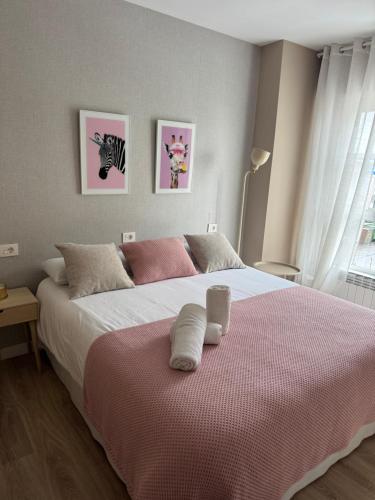 a bedroom with a large bed with two pillows on it at La Casa De Roma in Cambados