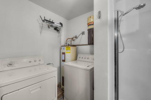 a small laundry room with a washer and dryer at 4 Jay Lane in Sunriver