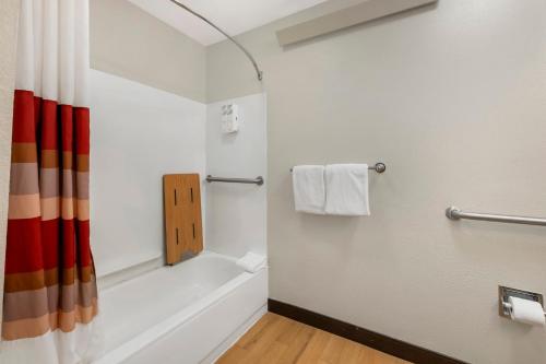 a bathroom with a bath tub and a shower at Red Roof Inn Buffalo - Niagara Airport in Williamsville