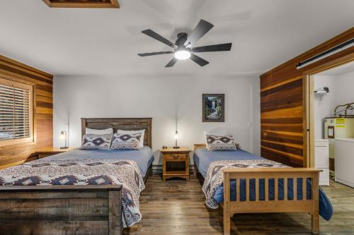 a bedroom with two beds and a ceiling fan at 4 Jay Lane in Sunriver