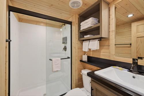 a bathroom with a shower and a toilet and a sink at Arches Hut in Moab