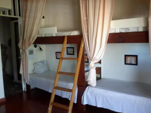 a room with two bunk beds and a ladder at Villa Mar Sosua in Sosúa