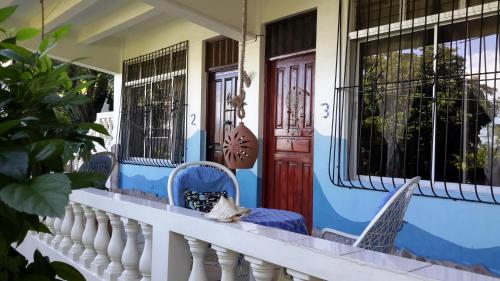 a porch of a house with blue and white at Villa Mar Sosua in Sosúa