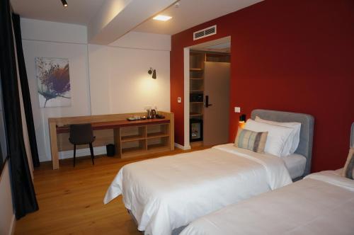 Ένα ή περισσότερα κρεβάτια σε δωμάτιο στο Hotel Mooma