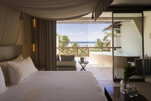a bedroom with a bed and a view of the ocean at Azure Horizon Suite in Balcheil