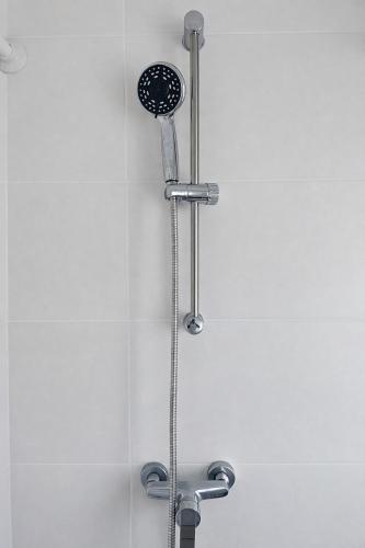 a shower with a shower head in a bathroom at Studio Apartment 1- Komfort & Günstig in Berlin