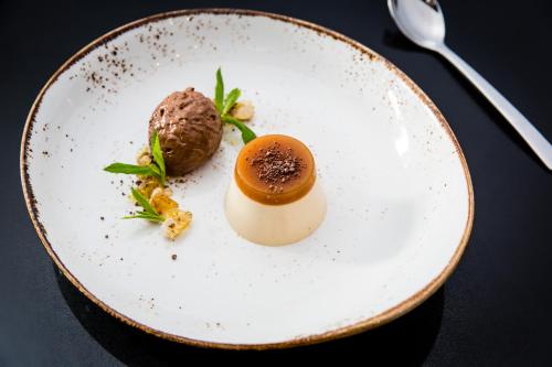 a white plate with a dessert on a table at Pullman Sydney Airport in Sydney