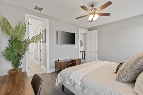 a bedroom with a bed and a ceiling fan at Gated Parking + Fire Pit | Near Zoo + Rhodes in Memphis