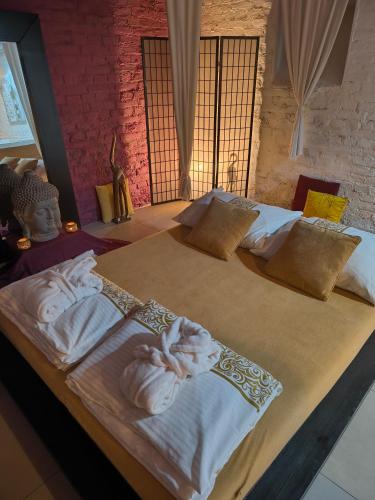 a bedroom with two beds with towels on them at iRelax studio - privatni wellness in Prague