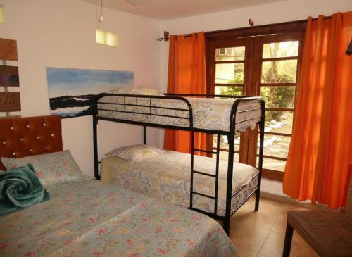 a bedroom with two bunk beds and a window at Casa del Sol Bed and Breakfast in Contadora