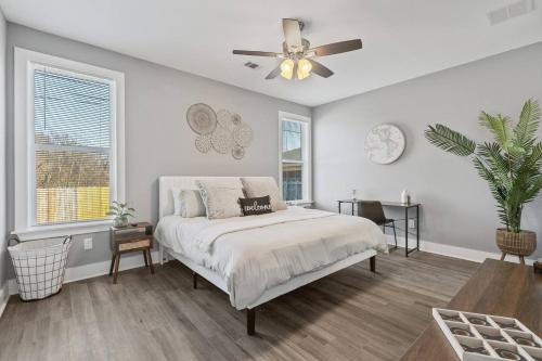 a bedroom with a bed and a ceiling fan at Gated Parking + Fire Pit | Near Zoo + Rhodes in Memphis